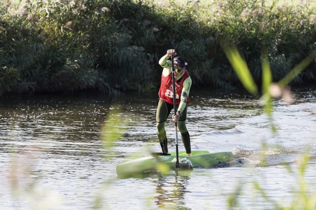 Stand-up paddler on calm Atlantic water beside the Azores coast
